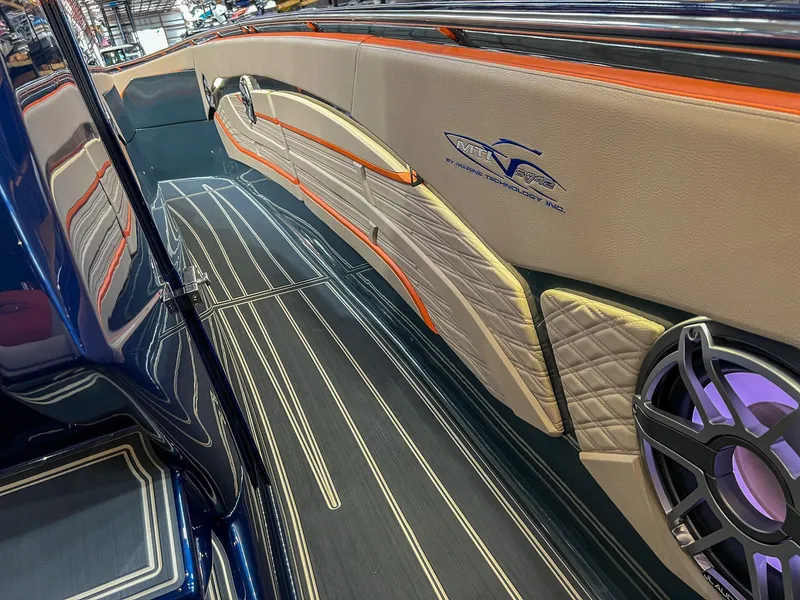 Slide: The Image of 2024 MTI V42 boat interior with sleek design, luxury seating, and modern speaker system. - 18