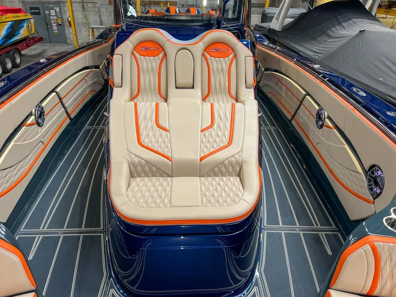 Slide: The Image of 2024 MTI V42 boat interior with luxurious seating and vibrant orange accents. - 21