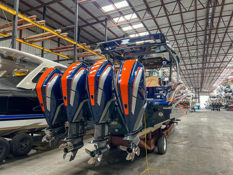 Slide: The Image of 2024 MTI V42 boat with four powerful outboard engines in a warehouse setting. - 23