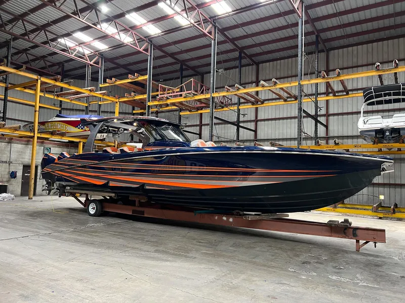 Slide: The Image of 2024 MTI V42 boat with sleek design in a warehouse setting. - 25