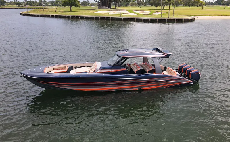 Slide: The Image of 2024 MTI V42 luxury boat with sleek design and powerful engines on a calm waterway. - 27