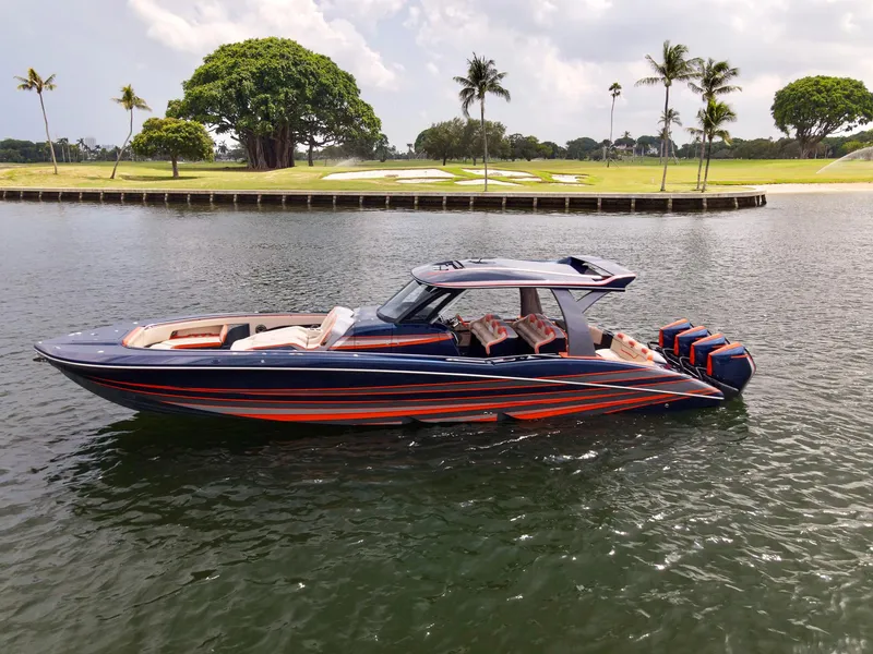 Slide: The Image of 2024 MTI V42 boat with sleek design, vibrant colors, cruising on a calm waterway. - 28