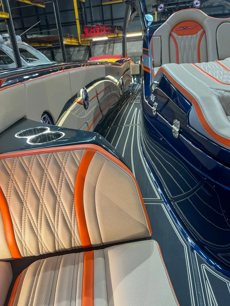 Slide: The Image of 2024 MTI V42 boat interior with luxurious orange and beige seating, sleek design. - 7
