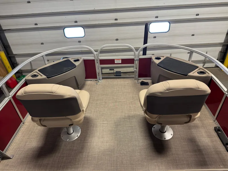 Slide: The Image of 2025 Sun Tracker Bass Buggy 18 DLX pontoon boat interior with two beige seats. - 10