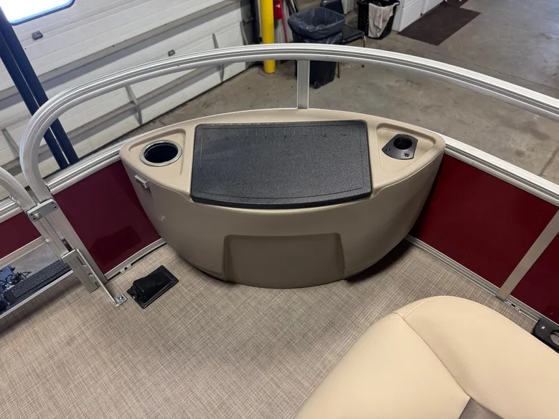 Slide: The Image of 2025 Sun Tracker Bass Buggy 18 DLX pontoon boat interior with seating and storage. - 8