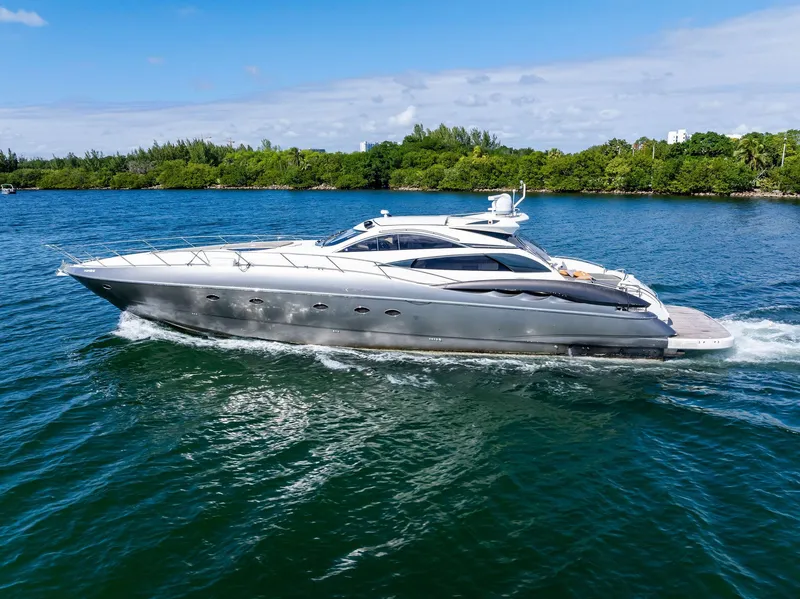 Slide: The Image of 2001 Sunseeker Predator 75 yacht cruising on a serene blue waterway. - 1
