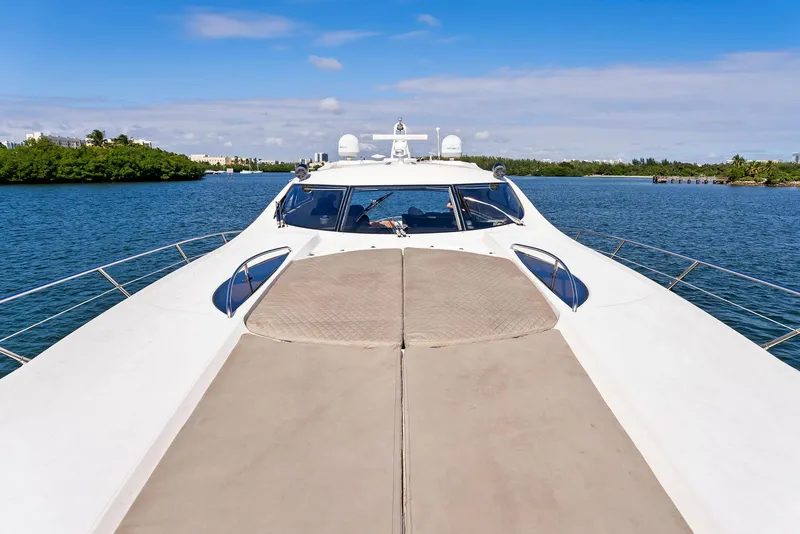 Slide: The Image of Sunseeker Predator 75 yacht, 2001 model, cruising on a serene blue waterway. - 17