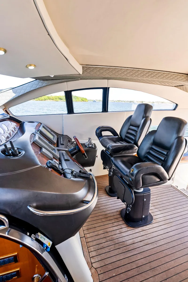 Slide: The Image of Interior helm of 2001 Sunseeker Predator 75 yacht with leather seats and control panel. - 24