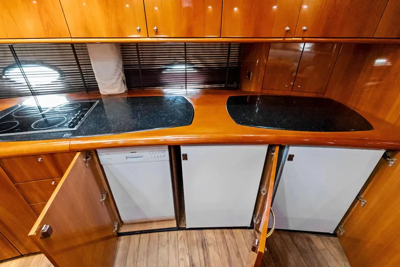 Slide: The Image of Luxurious kitchen interior of 2001 Sunseeker Predator 75 yacht with wood cabinetry and modern appliances. - 33