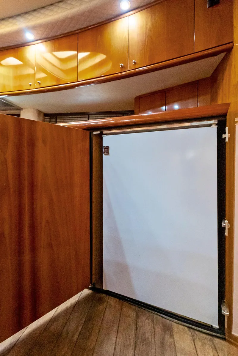 Slide: The Image of Interior of 2001 Sunseeker Predator 75 yacht with wooden cabinetry and built-in refrigerator. - 34