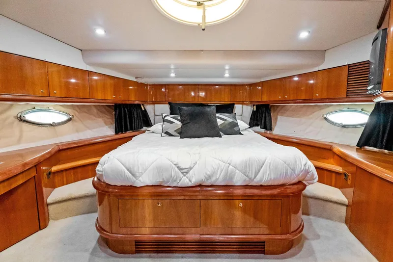Slide: The Image of Luxurious bedroom interior of 2001 Sunseeker Predator 75 yacht with wood accents. - 35