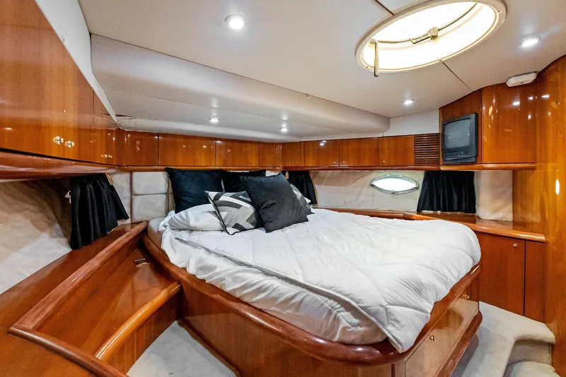 Slide: The Image of Luxurious cabin interior of 2001 Sunseeker Predator 75 yacht with wood finish and cozy bedding. - 38
