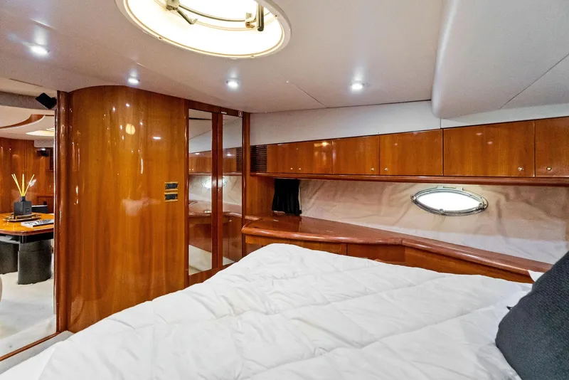 Slide: The Image of Luxurious interior of 2001 Sunseeker Predator 75 yacht with wood paneling and cozy bedding. - 39