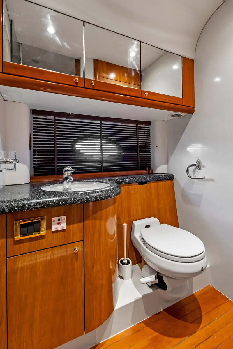 Slide: The Image of Luxurious bathroom in 2001 Sunseeker Predator 75 yacht with wood accents and modern fixtures. - 43