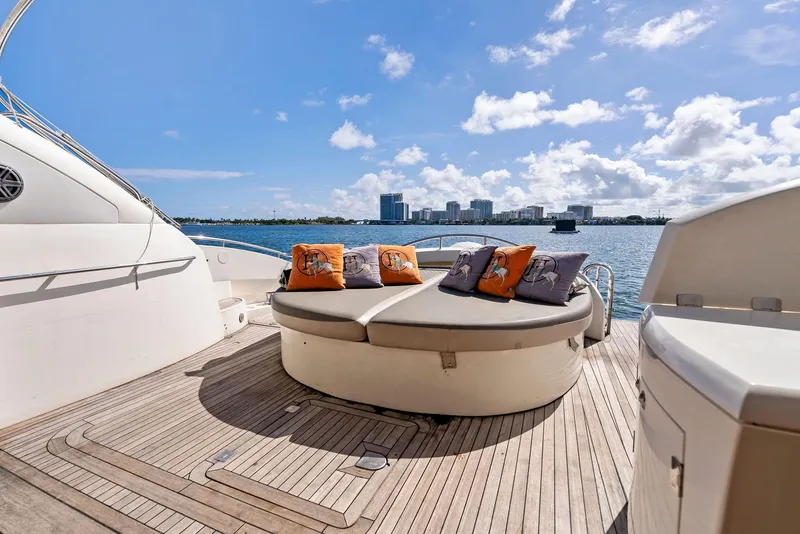 Slide: The Image of Luxurious Sunseeker Predator 75 yacht deck with stylish seating, ocean view, and city skyline. - 9