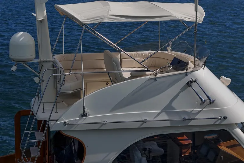 Slide: The Image of 2006 Hinckley Talaria 44 FB yacht with flybridge and canopy on open water. - 14