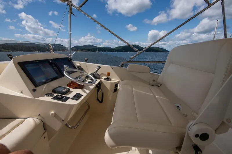 Slide: The Image of 2006 Hinckley Talaria 44 FB yacht helm with luxurious seating and scenic ocean view. - 18