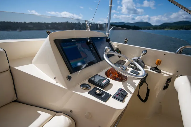 Slide: The Image of Helm of 2006 Hinckley Talaria 44 FB yacht with navigation screens and steering wheel. - 19