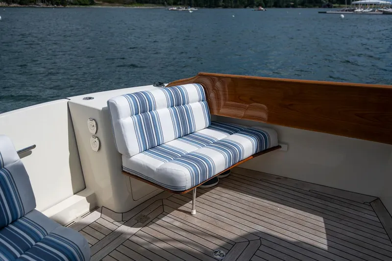 Slide: The Image of Hinckley Talaria 44 FB 2006 boat with striped seating and wooden accents on deck. - 23