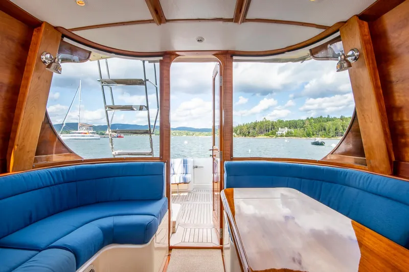 Slide: The Image of Interior view of 2006 Hinckley Talaria 44 FB yacht with blue seating and scenic water backdrop. - 26