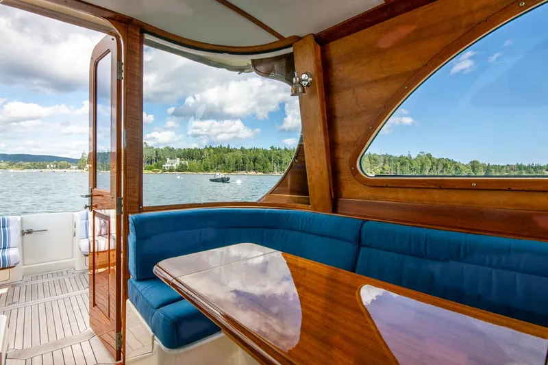 Slide: The Image of Interior of 2006 Hinckley Talaria 44 FB yacht with blue seating and wooden table. - 27