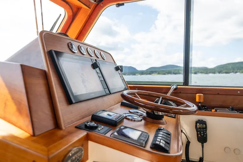 Slide: The Image of Helm of 2006 Hinckley Talaria 44 FB yacht with navigation equipment and scenic view. - 30