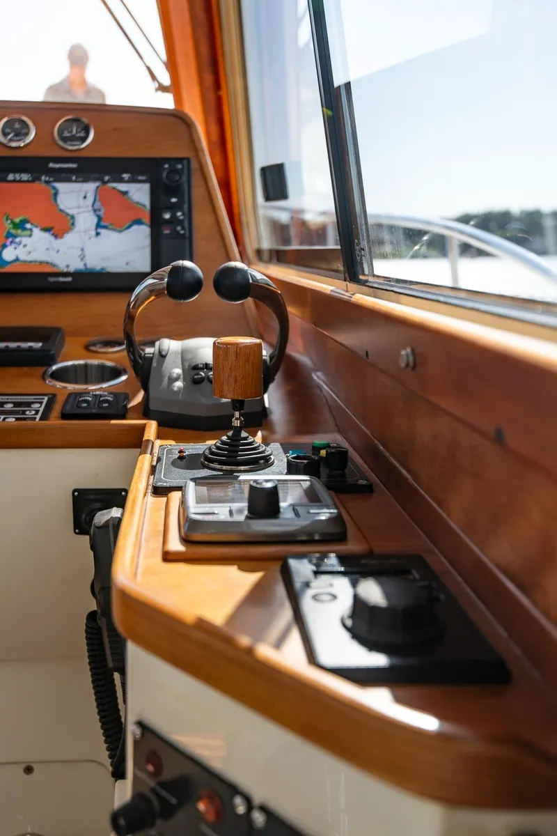 Slide: The Image of 2006 Hinckley Talaria 44 FB helm with navigation controls and display. - 33