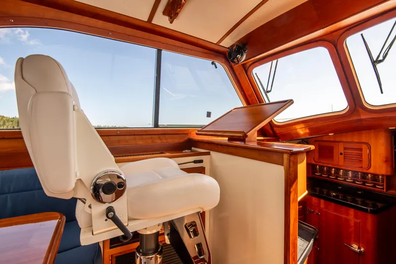 Slide: The Image of Interior of 2006 Hinckley Talaria 44 FB yacht with captain's chair and wooden dashboard. - 34