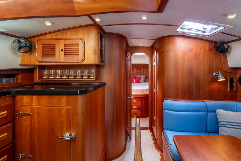Slide: The Image of Luxurious interior of 2006 Hinckley Talaria 44 FB yacht with wood finish and blue seating. - 38