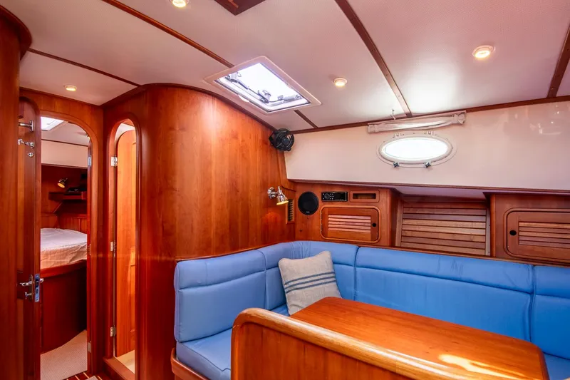 Slide: The Image of Luxurious interior of 2006 Hinckley Talaria 44 FB yacht with blue seating and wood finish. - 39