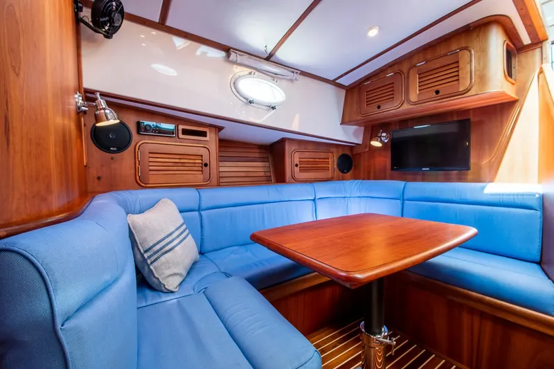 Slide: The Image of Luxurious interior of 2006 Hinckley Talaria 44 FB yacht with blue seating and wooden accents. - 40