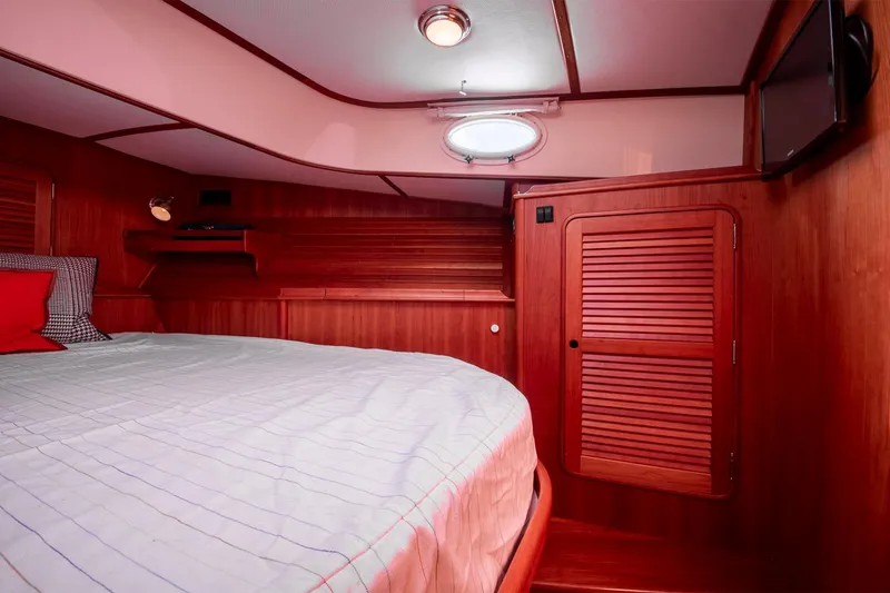 Slide: The Image of Luxurious cabin interior of 2006 Hinckley Talaria 44 FB yacht with wood paneling and cozy bed. - 42