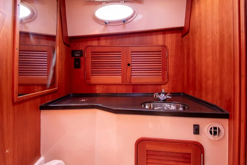 Slide: The Image of 2006 Hinckley Talaria 44 FB yacht bathroom with wood paneling and sink. - 44
