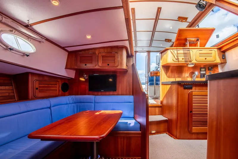 Slide: The Image of 2006 Hinckley Talaria 44 FB yacht interior with wood finish and blue seating. - 47