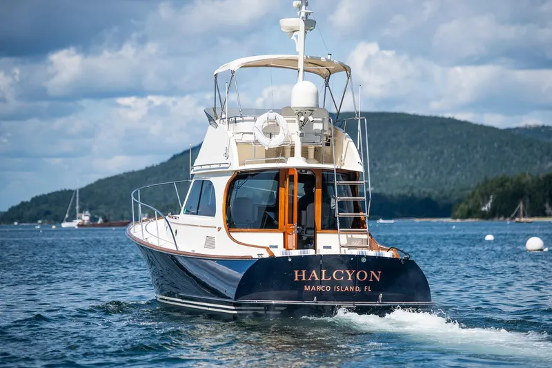 Slide: The Image of 2006 Hinckley Talaria 44 FB yacht cruising on scenic waters. - 48