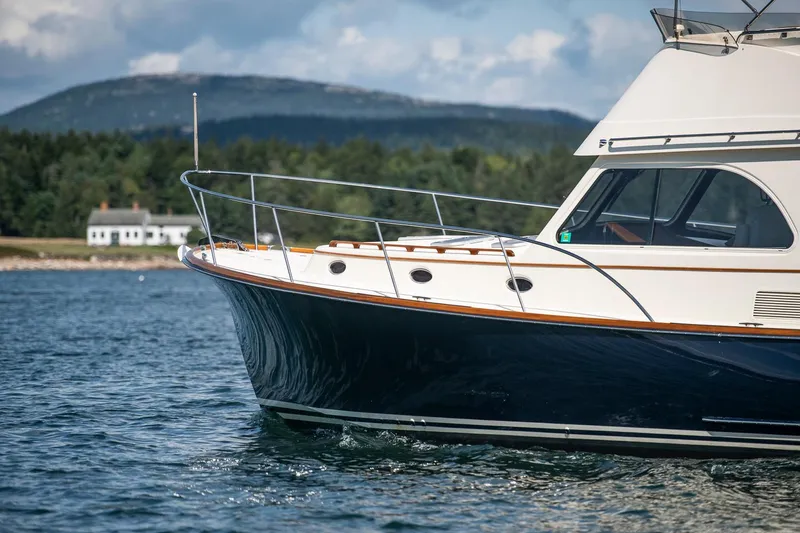 Slide: The Image of 2006 Hinckley Talaria 44 FB yacht on scenic water with mountain backdrop. - 8