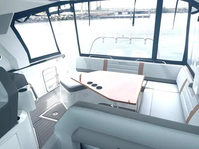 Slide: The Image of Interior of 2022 Beneteau 32 Gran Turismo yacht with sleek seating and table. - 12