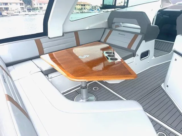 Slide: The Image of Luxurious seating area on 2022 Beneteau 32 Gran Turismo yacht with wooden table. - 14
