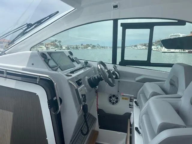 Slide: The Image of Interior of 2022 Beneteau 32 Gran Turismo yacht with modern helm and seating. - 20