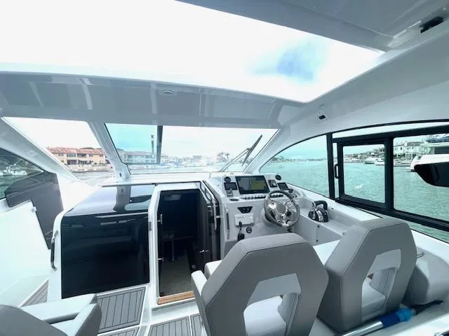 Slide: The Image of Interior of 2022 Beneteau 32 Gran Turismo yacht with modern helm and seating. - 22