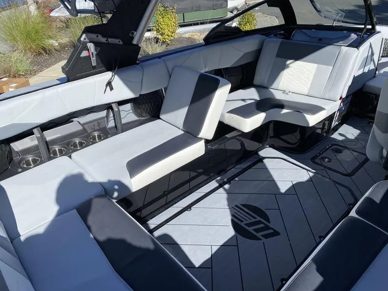Slide: The Image of 2025 Malibu 23 LSV boat interior with sleek seating and modern design. - 16