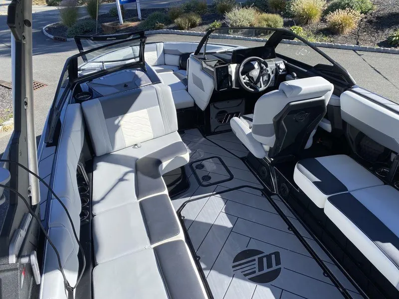 Slide: The Image of 2025 Malibu 23 LSV boat interior with sleek seating and modern dashboard design. - 9