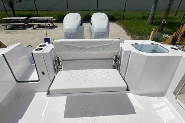 Slide: The Image of Aquasport 2800 AS 2025 boat with dual engines and seating area, docked outdoors. - 3