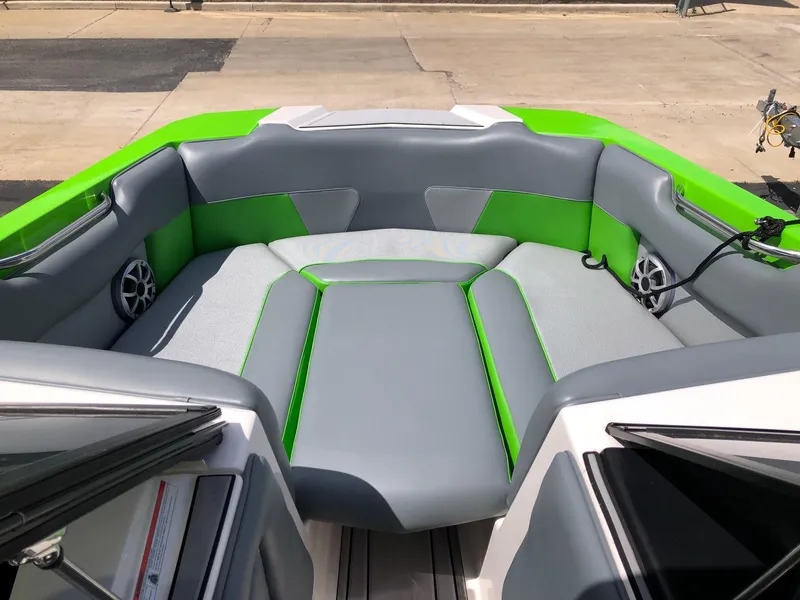 Slide: The Image of 2018 Moomba Max boat interior with gray and green seating. - 11