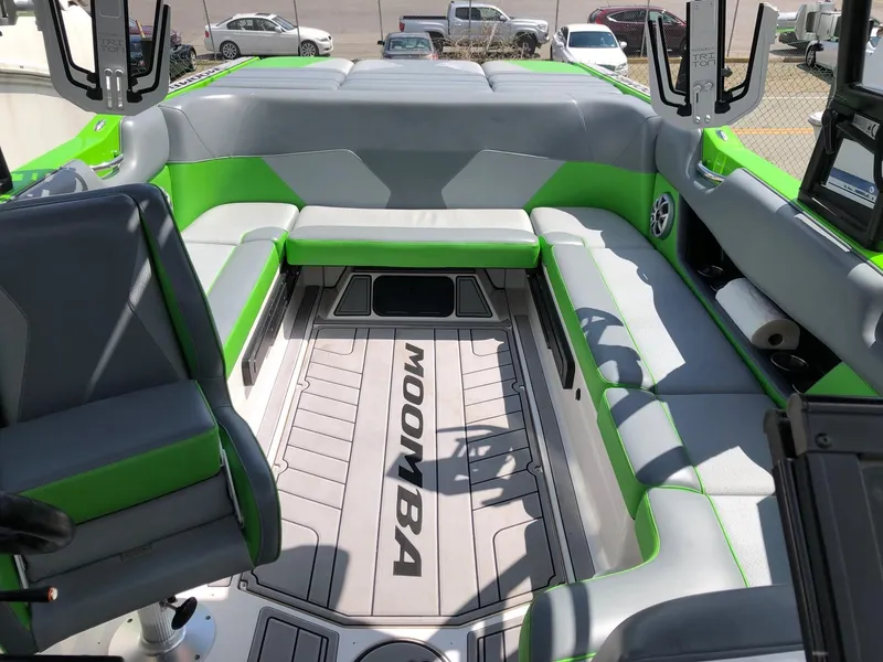Slide: The Image of 2018 Moomba Max boat interior with green and gray seating. - 12