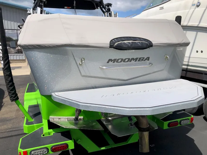 Slide: The Image of 2018 Moomba Max boat with green accents and covered rear deck. - 4