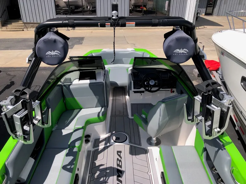 Slide: The Image of 2018 Moomba Max boat interior with green accents and advanced audio system. - 9
