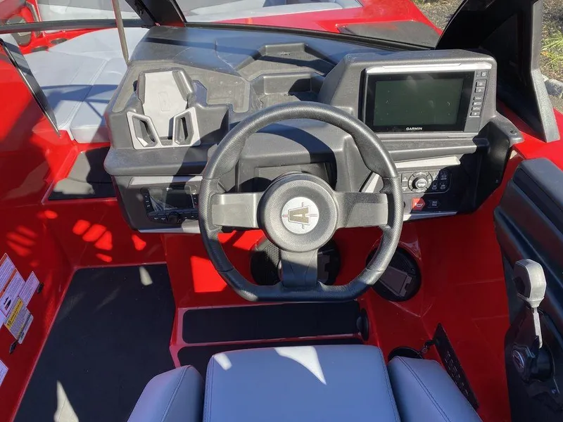 Slide: The Image of 2025 Axis A225 boat dashboard with steering wheel and digital display. - 11