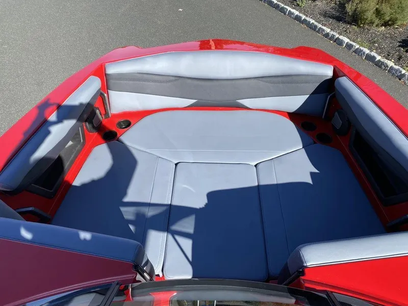 Slide: The Image of 2025 Axis A225 boat interior with red and gray seating, viewed from above. - 12