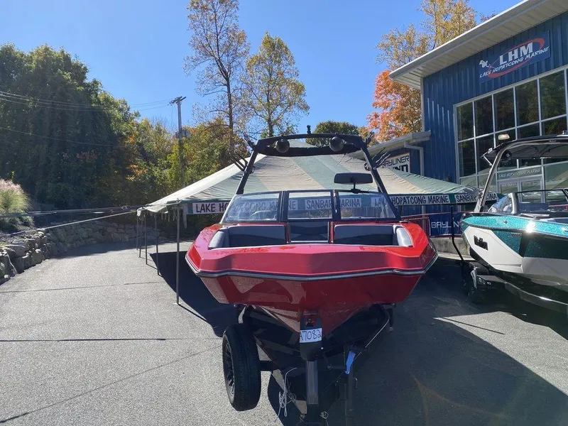 Slide: The Image of Red 2025 Axis A225 boat displayed outdoors at a dealership. - 7